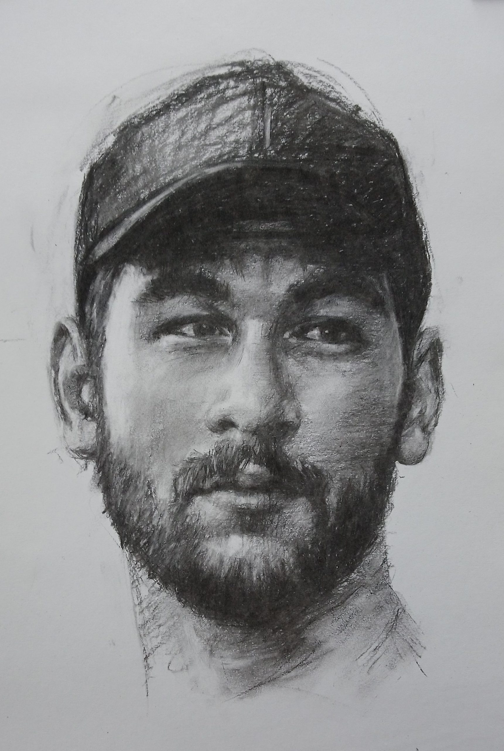 A young man with a beard and cap – Assignment