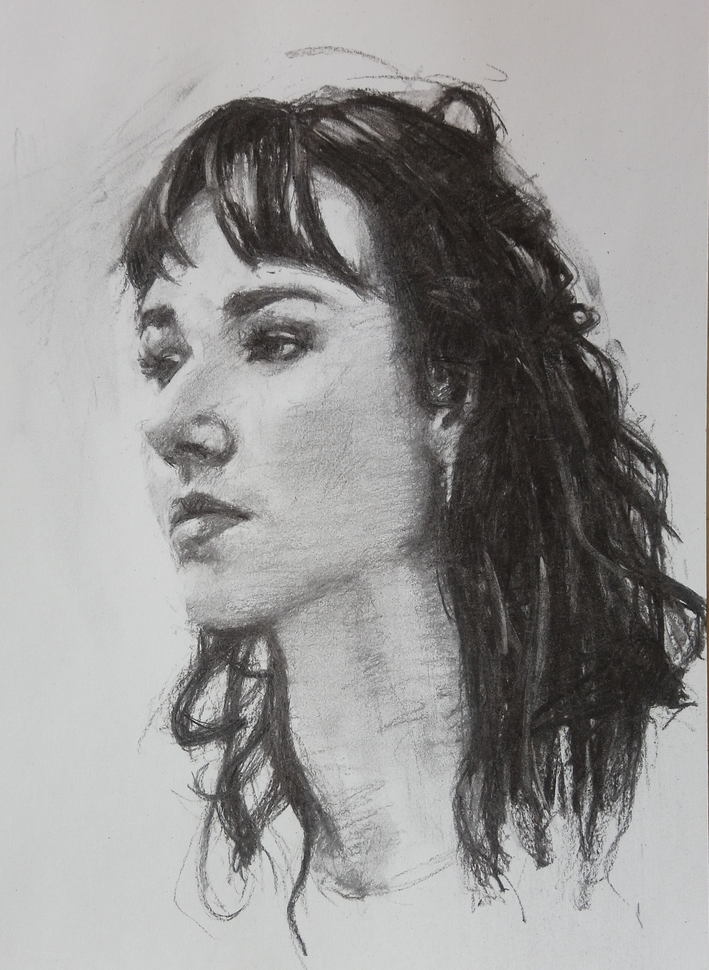 Drawing a young woman looking right in charcoal