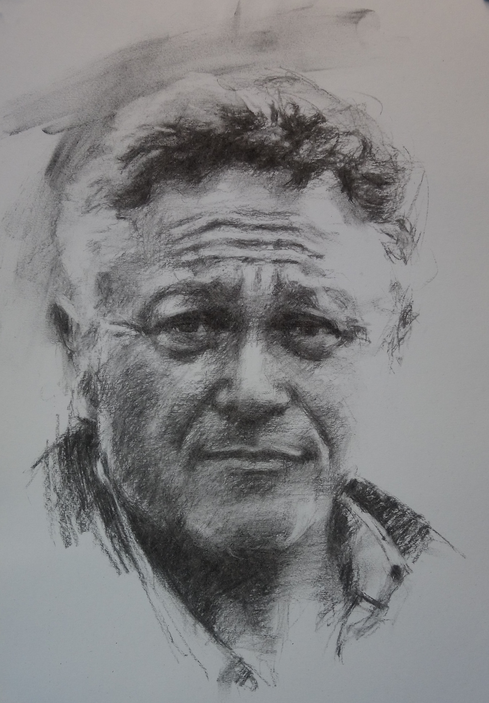 Drawing a mature male face in charcoal