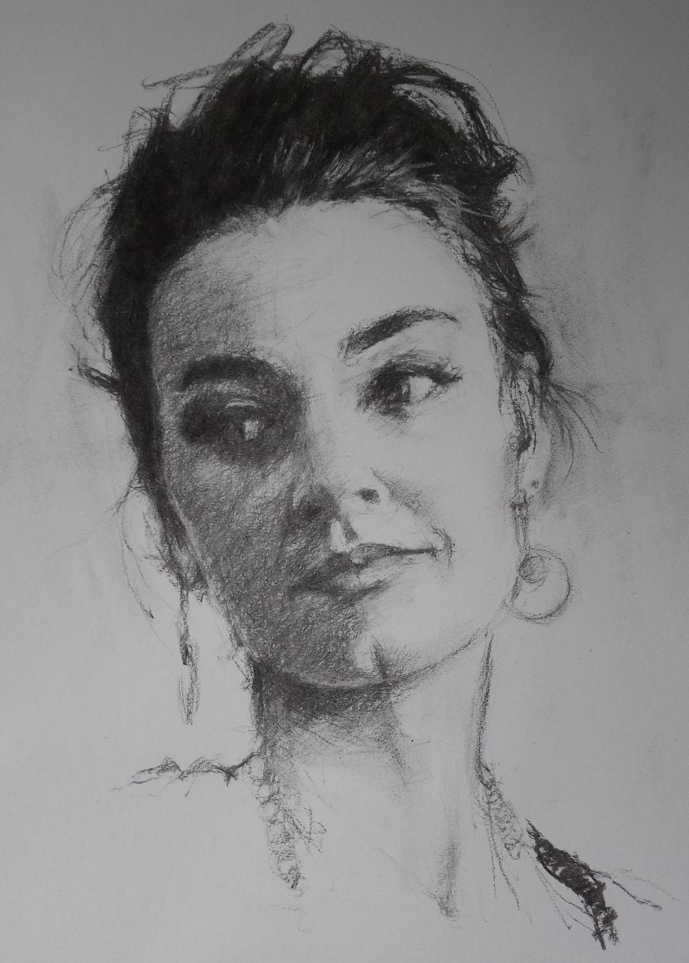 Drawing a woman glancing right in charcoal
