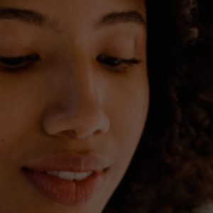 Girl looking down with curly hair